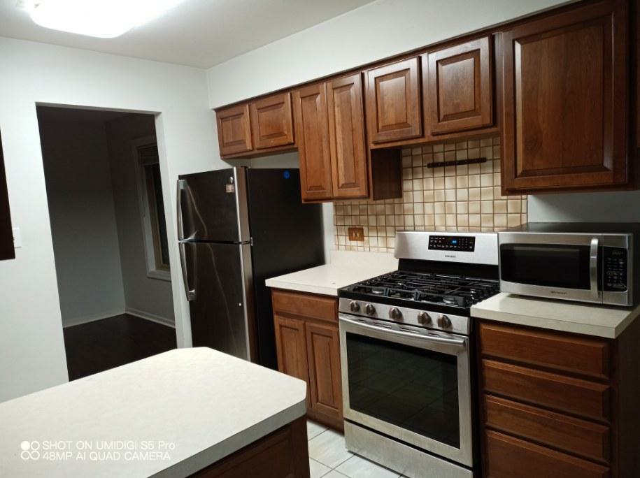 Clean kitchen with wood cabinets and stainless appliances after turnover