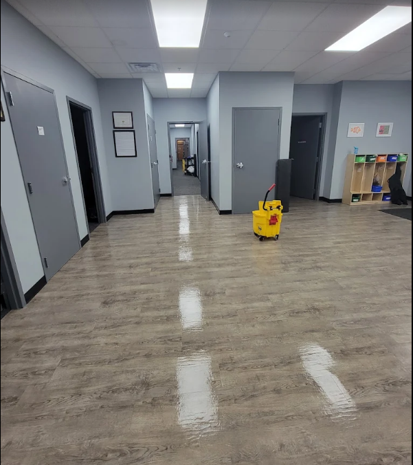 Polished commercial LVT floor after machine scrubbing in an open office